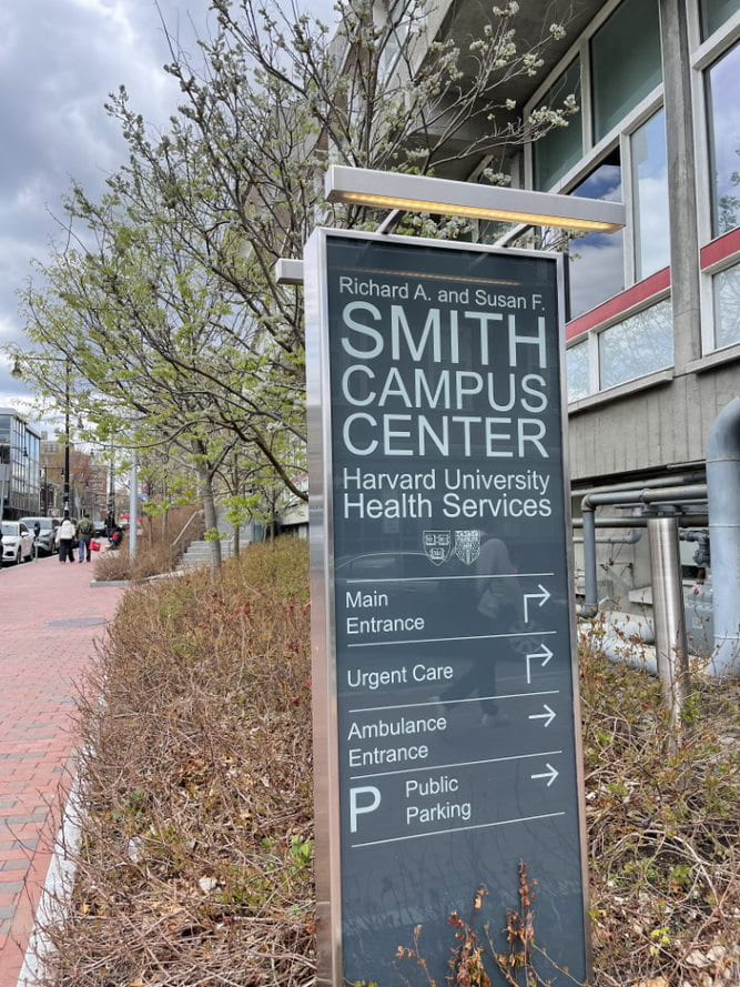 View of Smith Campus Center information signage outside the Harvard University Health Services clinic in Harvard Square