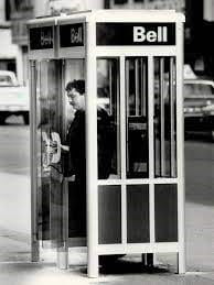Man in a 1970s phone booth